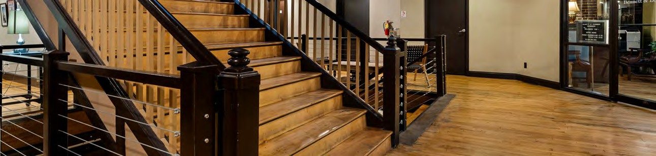 Open interior with hardwood floors and staircase